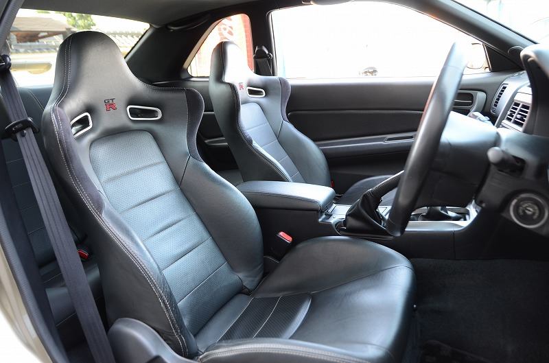 BNR34 M-Spec interior — Recaro seats with R embroidery, chrome shifter